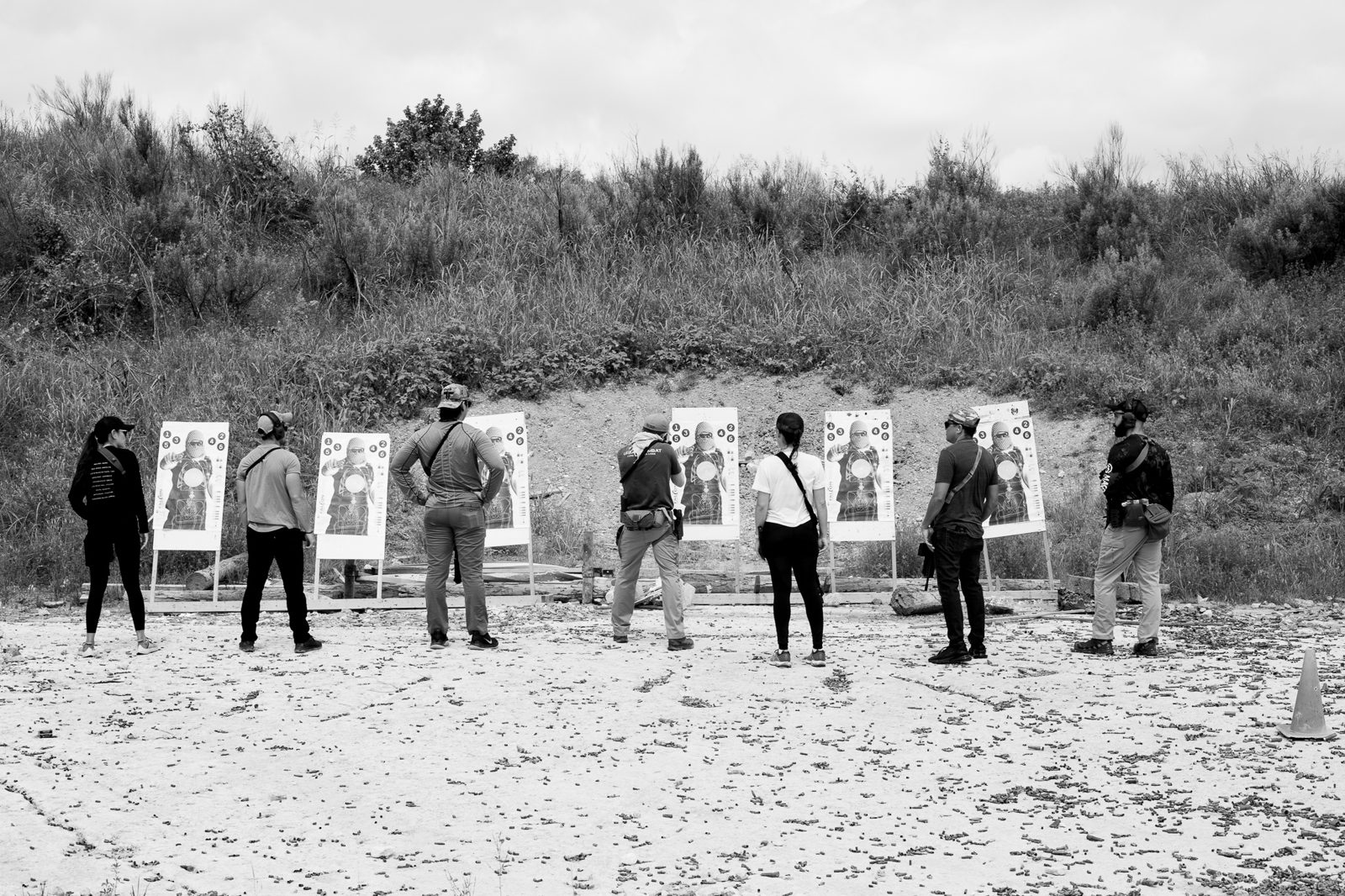 Corporate group assembled at targets during outdoor tactical offsite in Austin