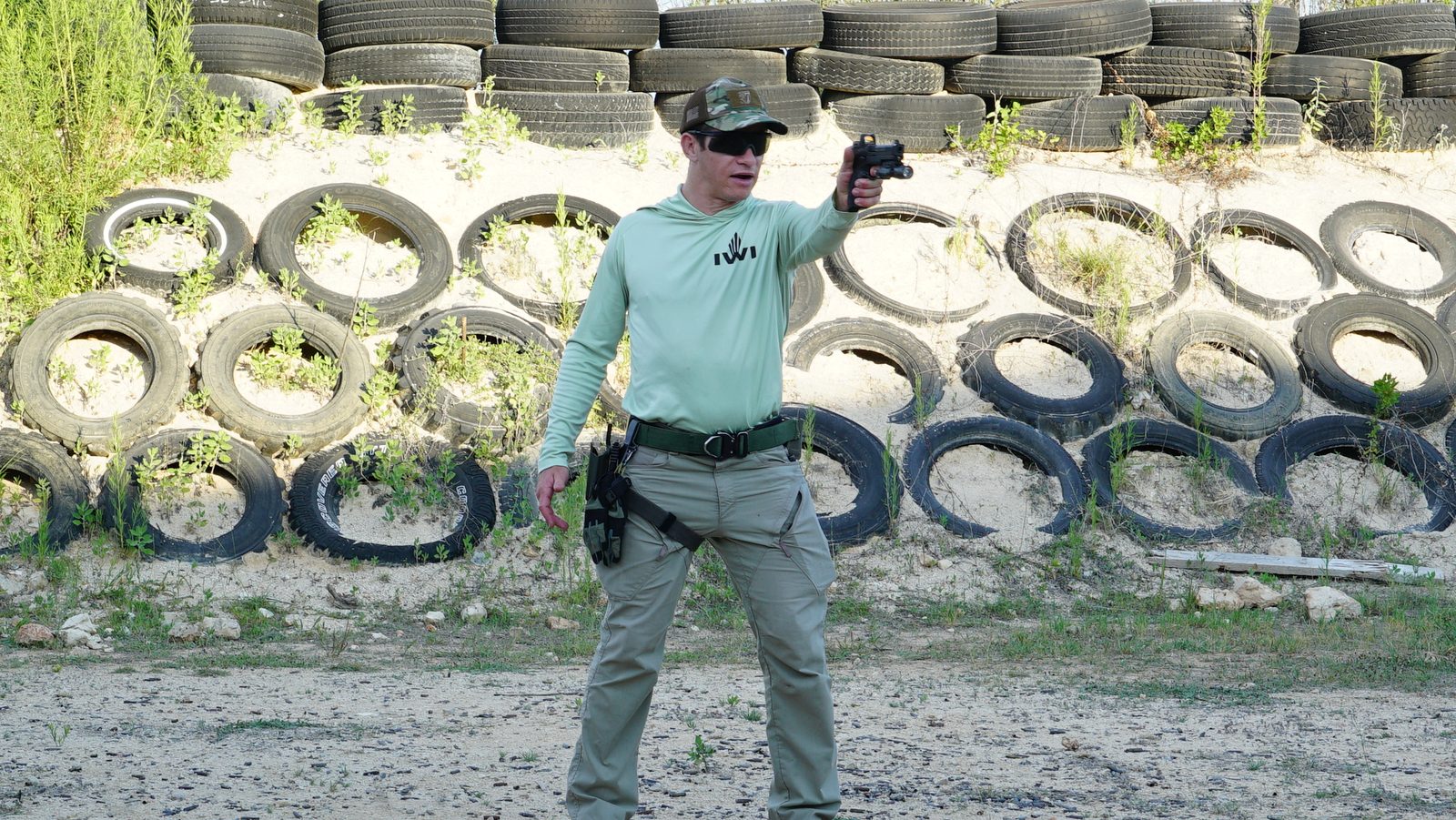 TFA certified instructor demonstrating pistol stance at private outdoor range Austin