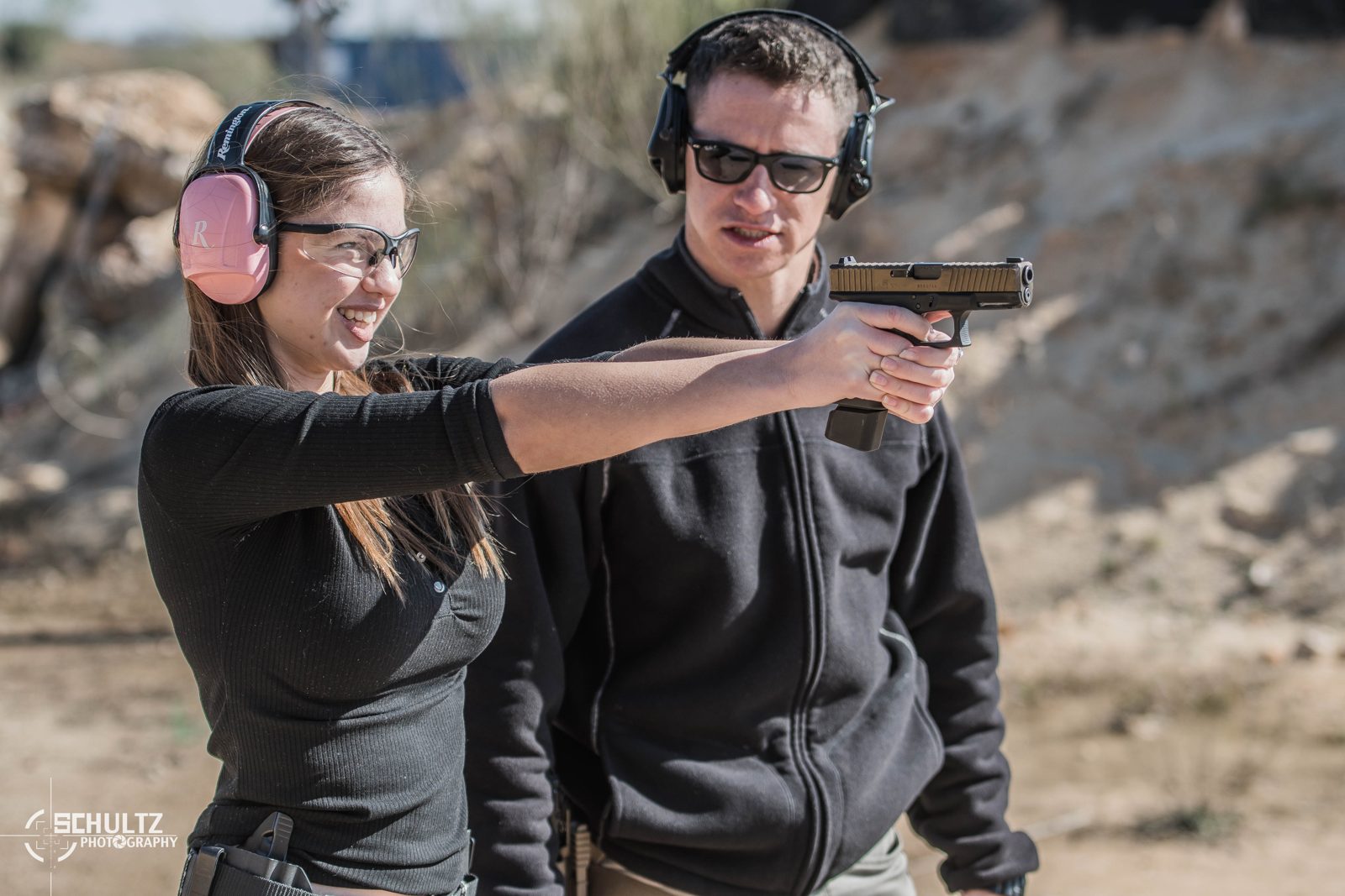 Women's firearms training Austin — instructor coaching pistol technique