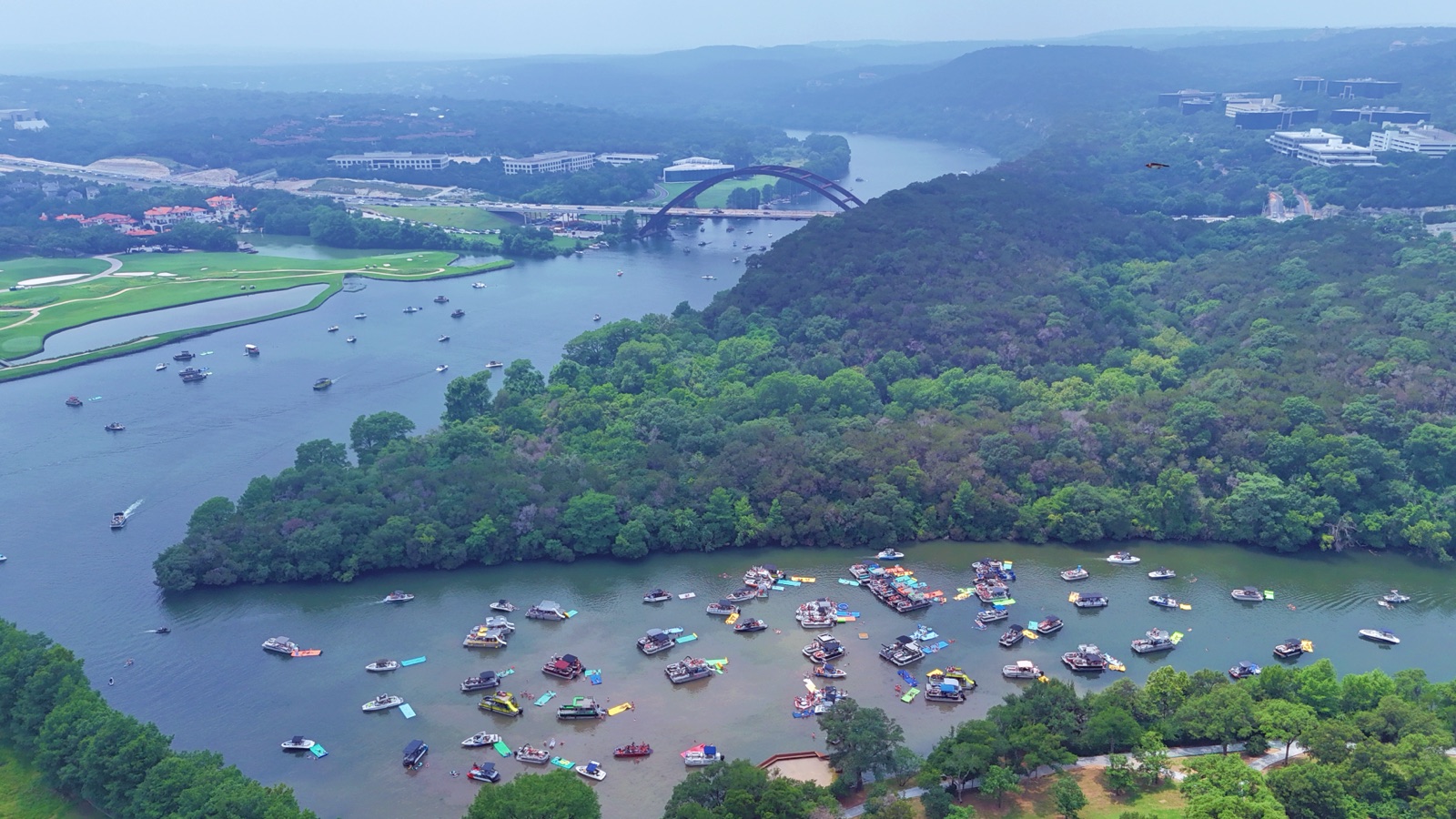 Aerial view of boats gathered on Lake Austin near the Pennybacker Bridge