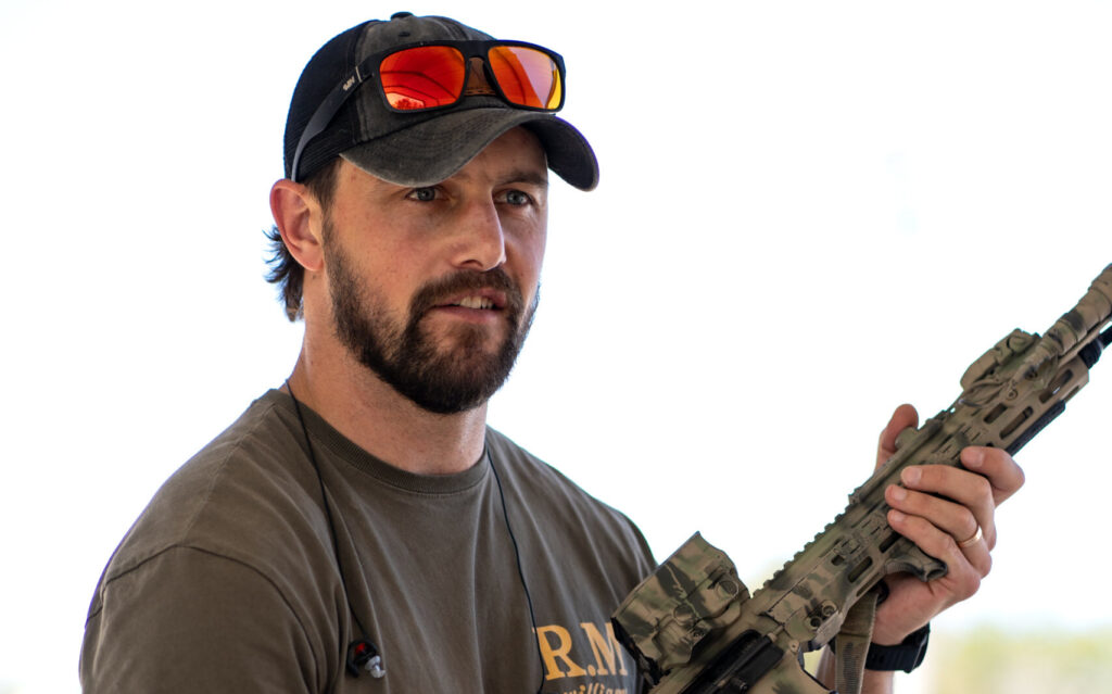 Shooter running an AR-15 on the rifle line