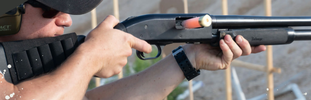 Shooter working a pump shotgun, shell ejecting