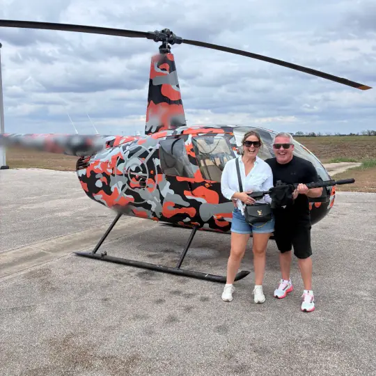 Couple at the helicopter before aerial gunnery